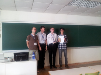 Photograph of organisers (Enrico H. Gerding, Valentin Robu and Colin R. Williams) presenting the first place winner (Jianye Hao) with his prize.