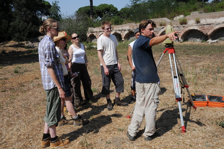 Teaching students how to use a total station next to the Terrazza di Traiano